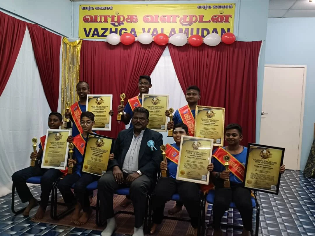 AMA students holding their Amazing Malaysian Book of Records certificates