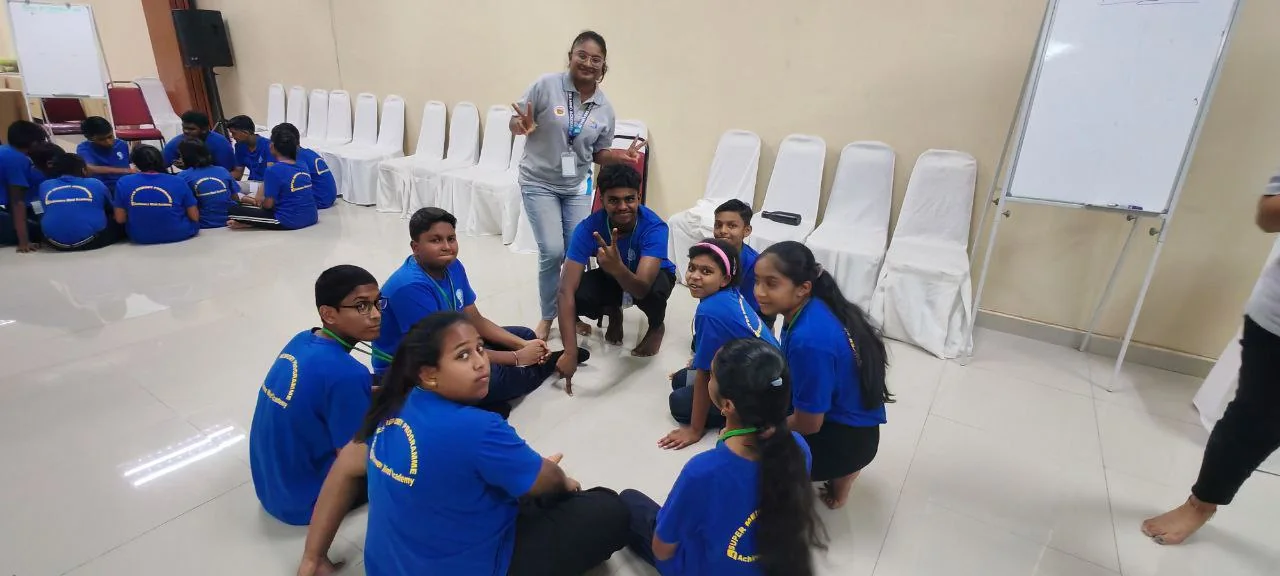Camp students working in a team circle