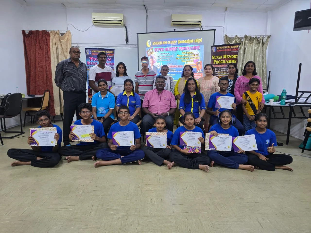 Students and trainers with certificates after an AMA session
