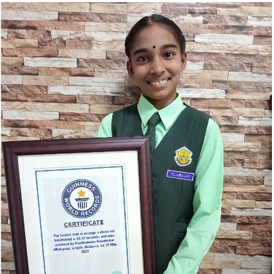Punithamalar Rajashekar holding her Guinness World Records certificate